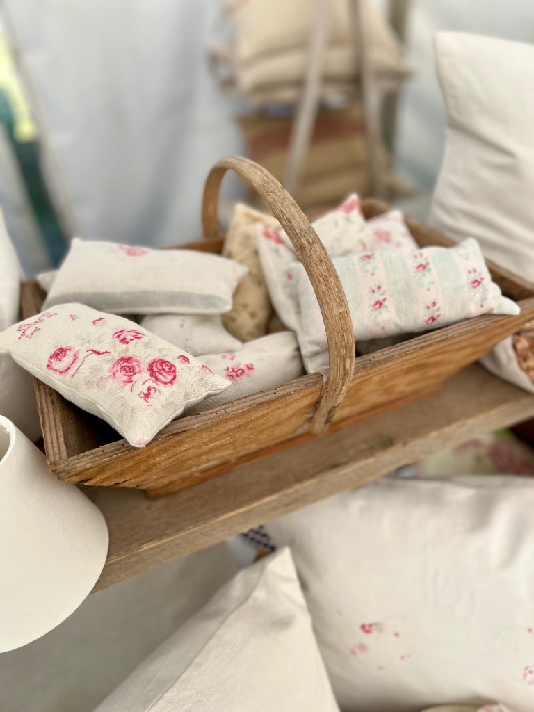 Handmade lavender sachets with vintage pink rose and floral stripe fabric in a rustic wooden trug basket